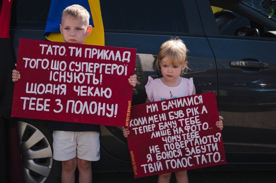 Діти подружжя тримали плакати під час однієї з акцій на підтримку батька, який був у полоні